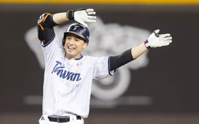 棒球選手穿著白色球衣比賽中揮手慶祝